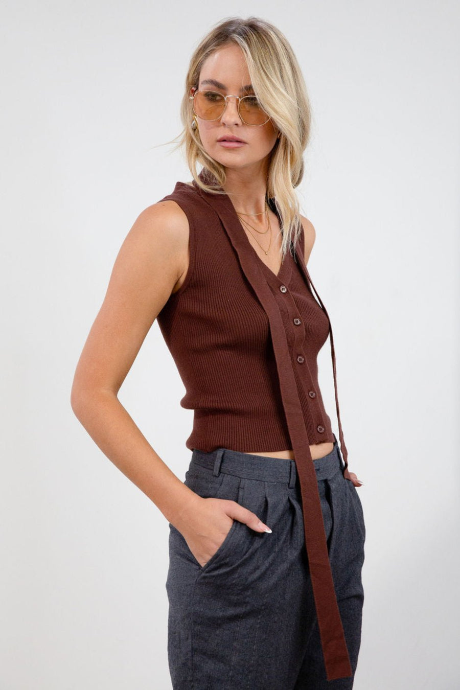 Ribbed knit sleeveless top. V-neckline. Front button down closure. Unlined. Neck tie. brown vest top. top with scarf. fall top.