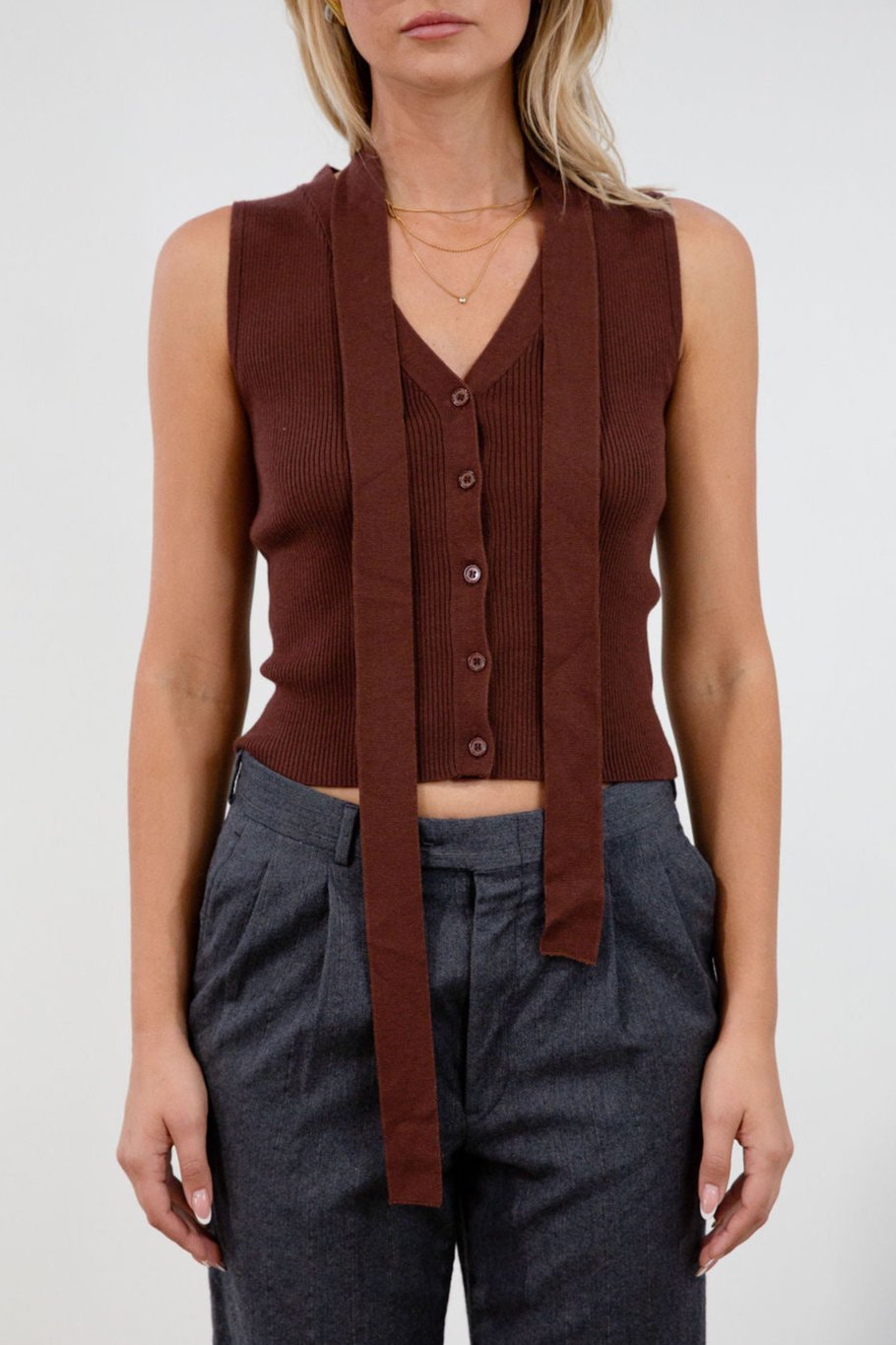 Ribbed knit sleeveless top. V-neckline. Front button down closure. Unlined. Neck tie. brown vest top. top with scarf. fall top.