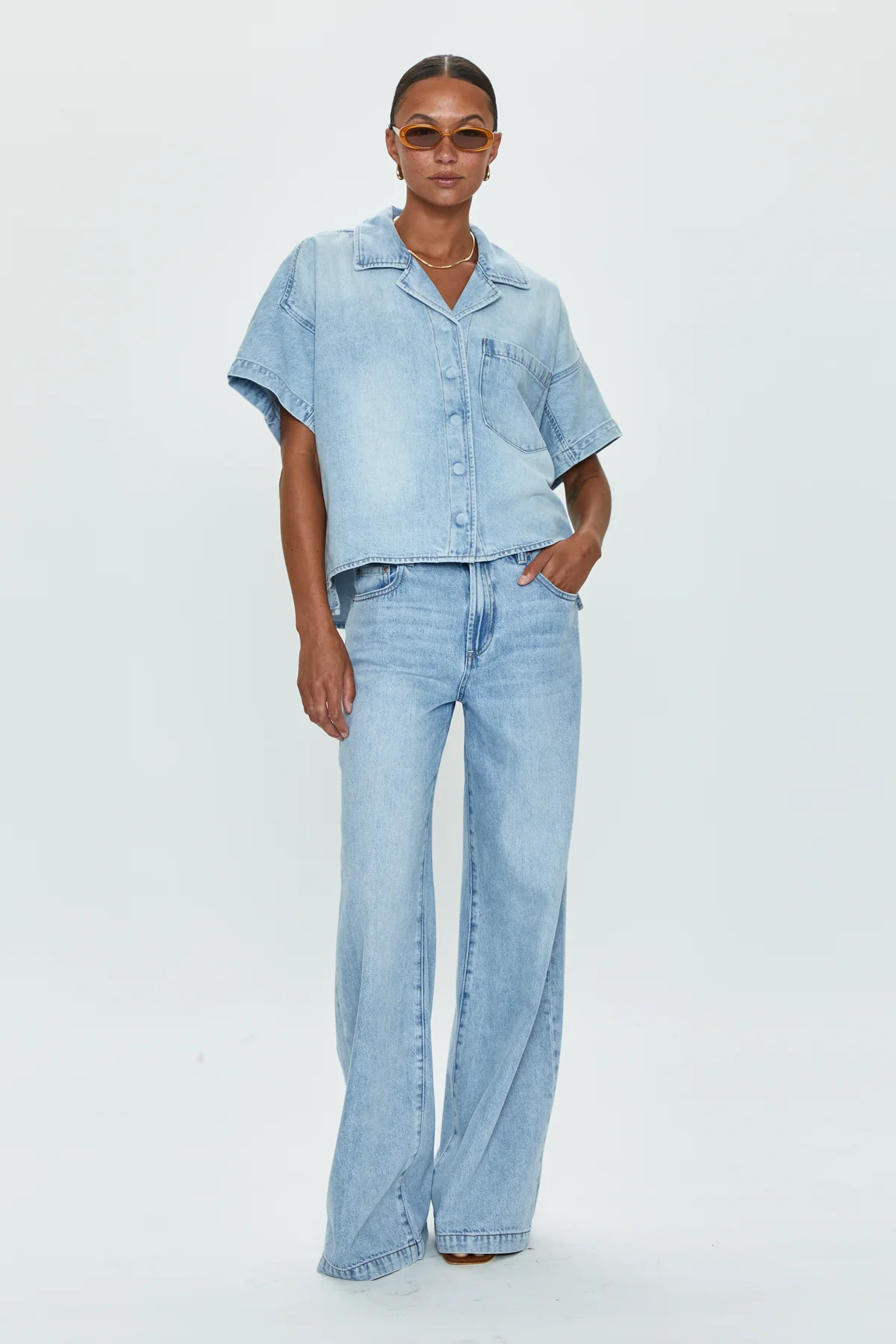 Low slung palazzo jeans. Button and zipper fly. Five pocket construction. Unlined. No stretch. baggy jeans. flare pant. light wash denim jeans
