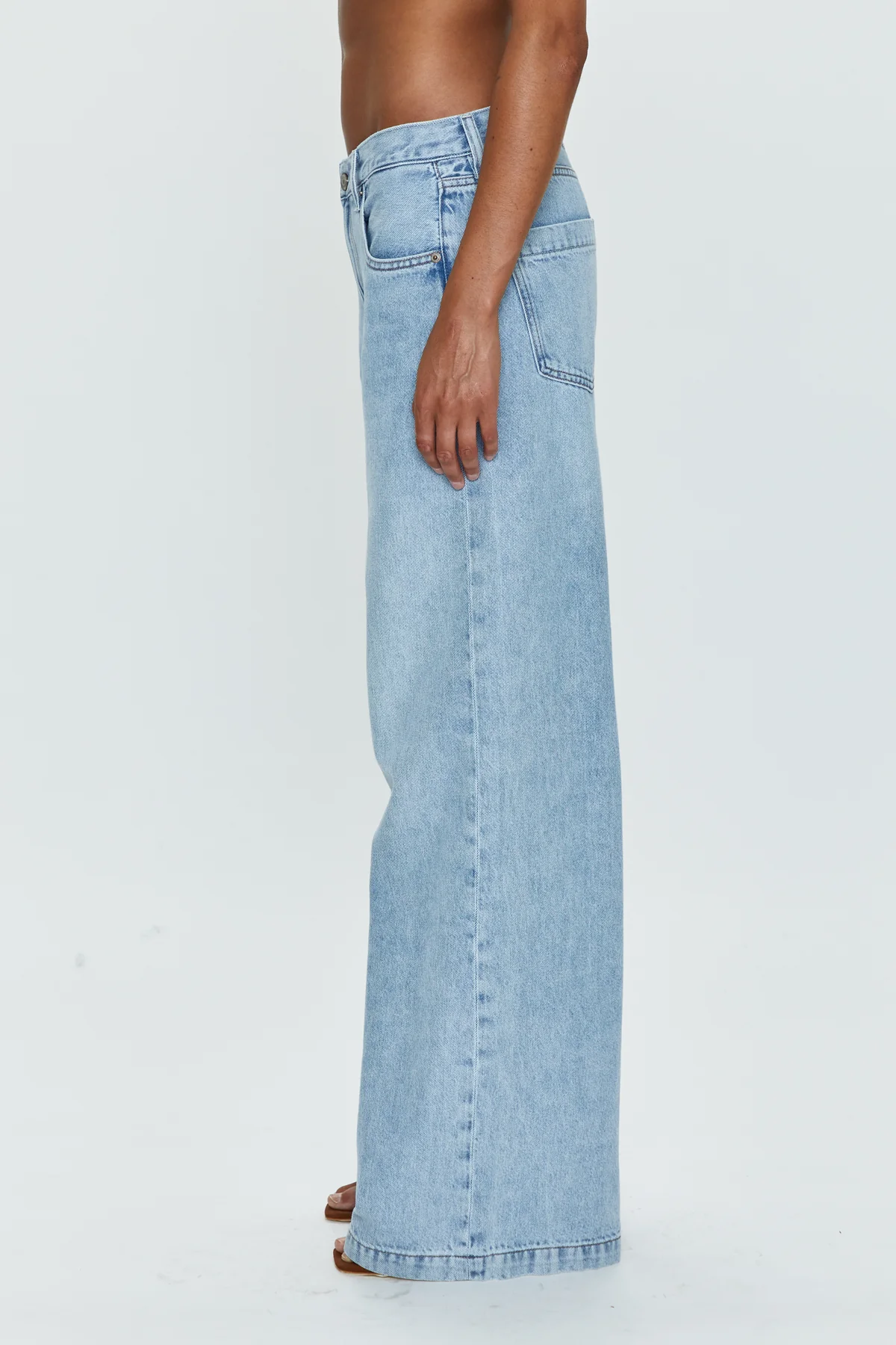 Low slung palazzo jeans. Button and zipper fly. Five pocket construction. Unlined. No stretch. baggy jeans. flare pant. light wash denim jeans