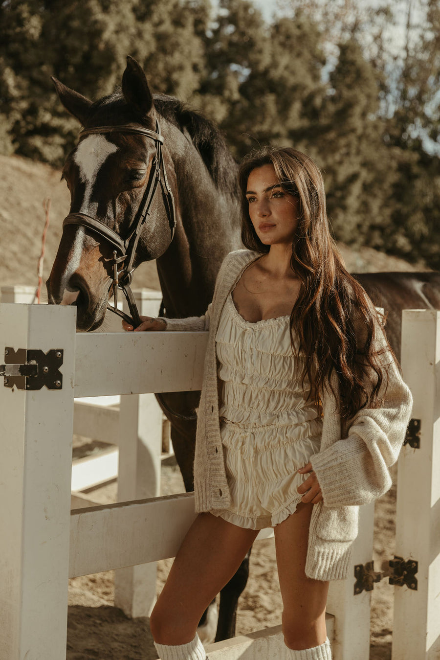 Smocked crop top. Short sleeves with elastic sleeve openings. Front tie closure. Fully lined. white smocked crop top.