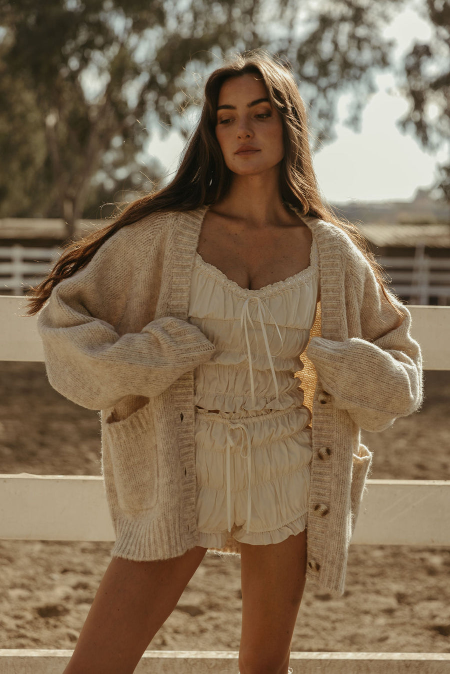 Smocked crop top. Short sleeves with elastic sleeve openings. Front tie closure. Fully lined. white smocked crop top.