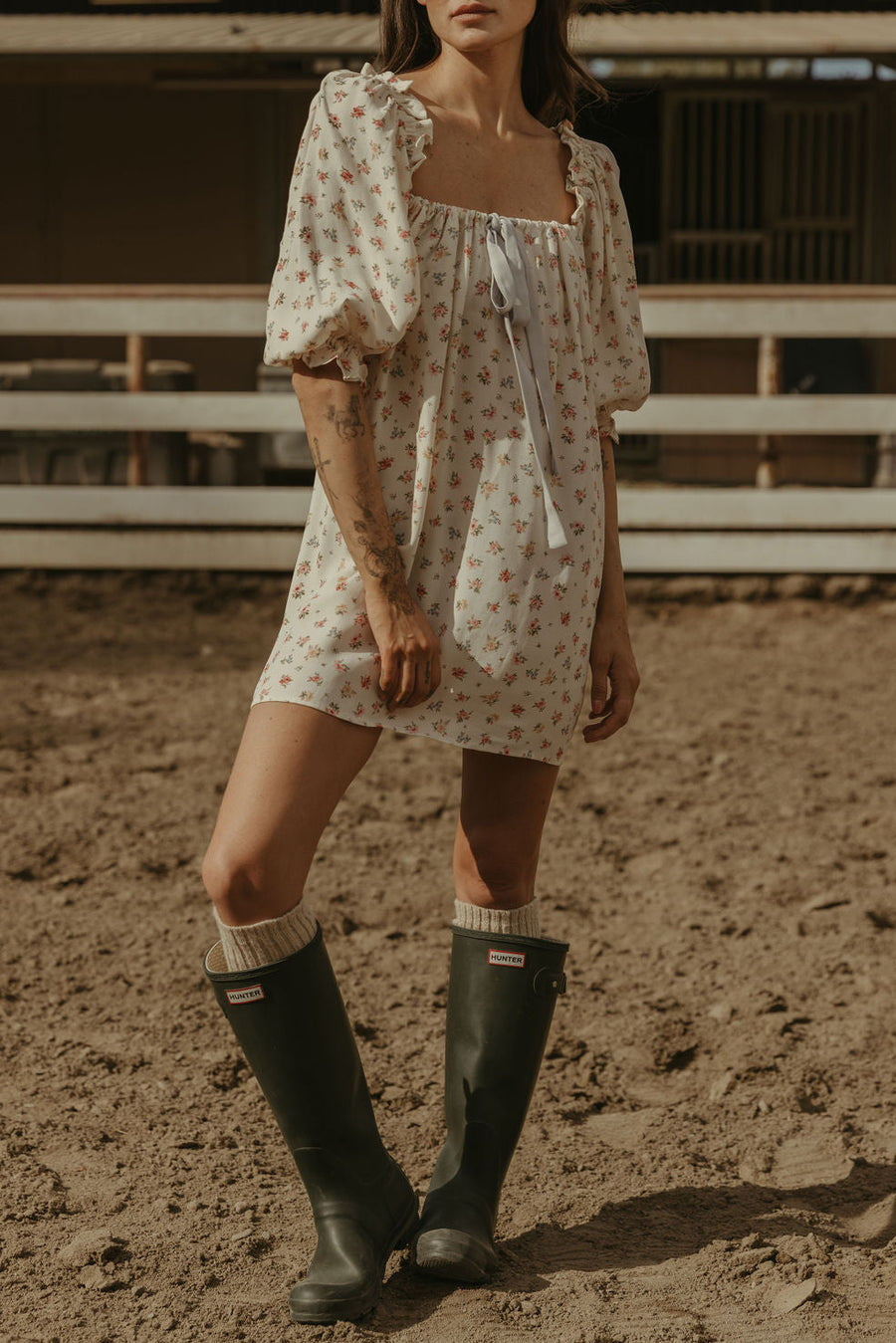 Floral printed woven dress. Elastic neckline. front tie closure. 3/4 sleeves with elastic openings. Unlined. floral mini dress. rumored mini dress. spring mini dress