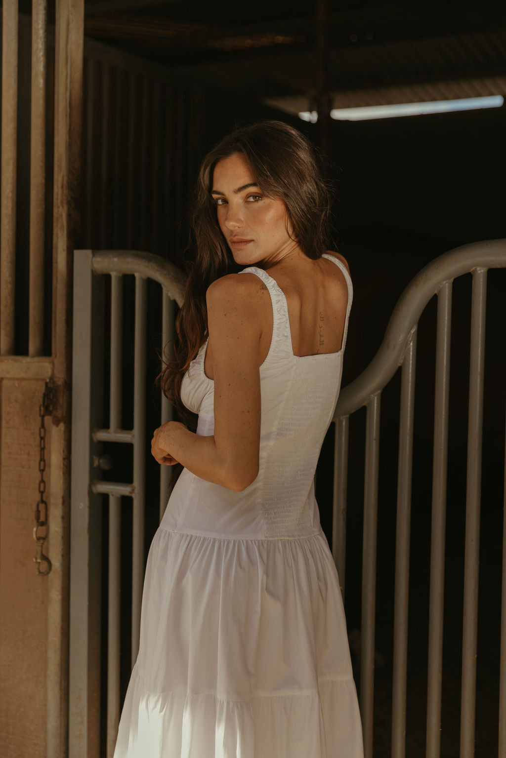 Woven maxi dress. Elastic straps. Faux front tie and button down closures. Tiered skirt. Elastic smocked back panel. Fully lined. white maxi dress