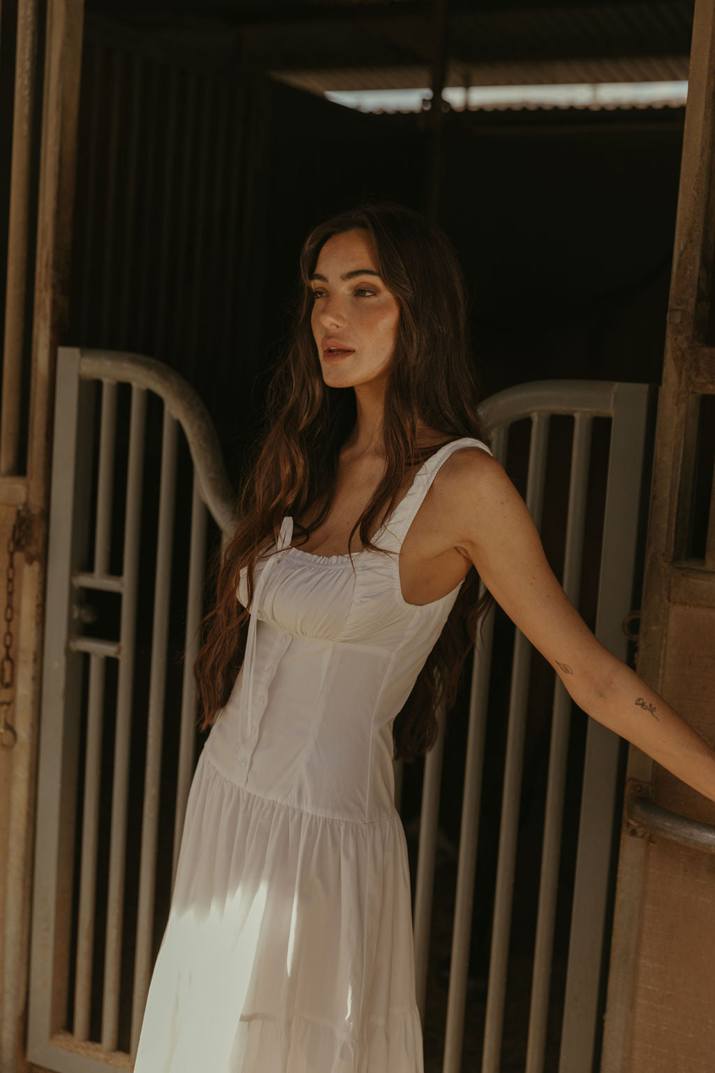 Woven maxi dress. Elastic straps. Faux front tie and button down closures. Tiered skirt. Elastic smocked back panel. Fully lined. white maxi dress