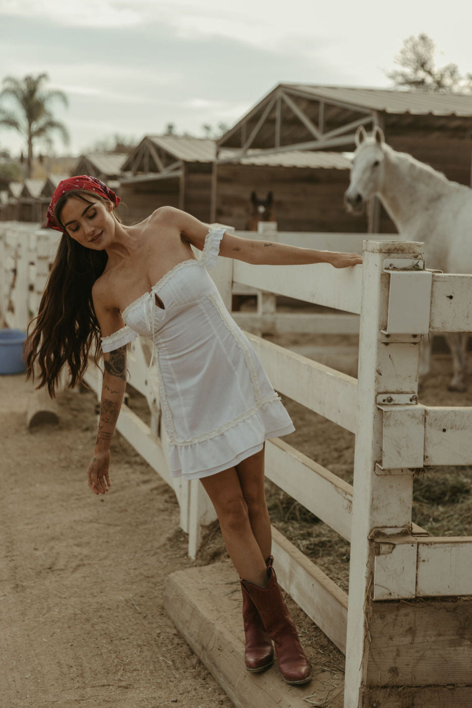 White Woven mini dress. Elastic straps. Inner rubber grip lining. Front tie closures. Crochet trim. Back hook and eye and zipper closures. Unlined. white sun dress