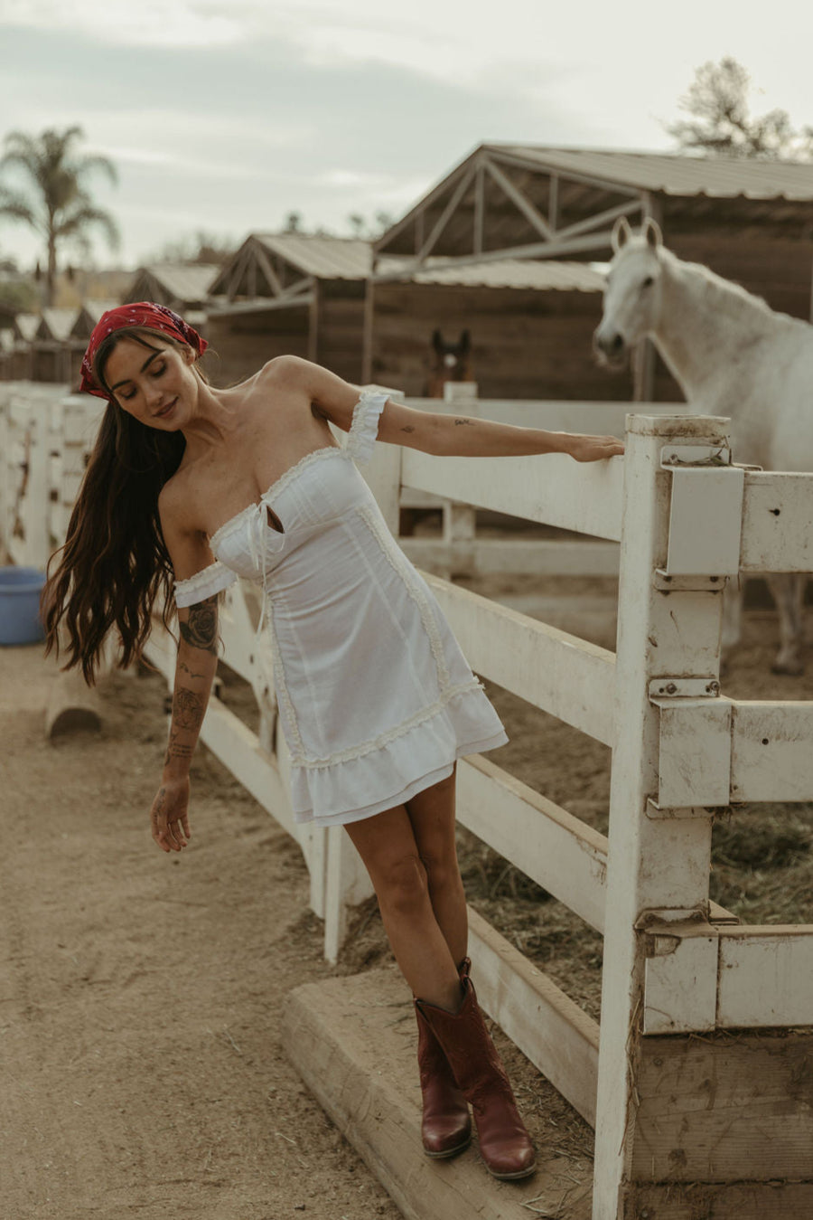 White Woven mini dress. Elastic straps. Inner rubber grip lining. Front tie closures. Crochet trim. Back hook and eye and zipper closures. Unlined. white sun dress
