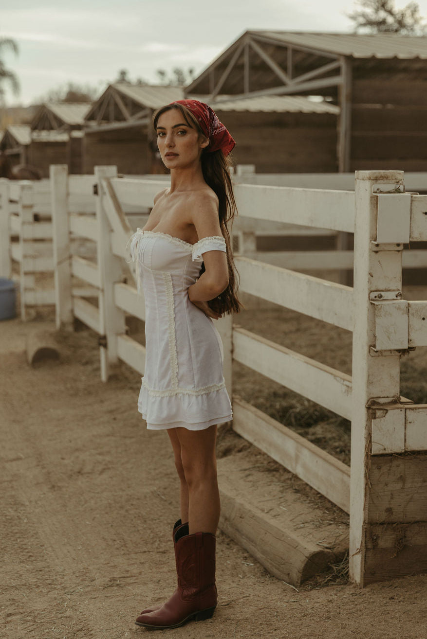 White Woven mini dress. Elastic straps. Inner rubber grip lining. Front tie closures. Crochet trim. Back hook and eye and zipper closures. Unlined. white sun dress
