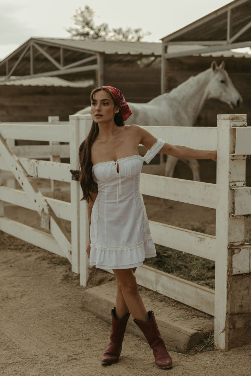 White Woven mini dress. Elastic straps. Inner rubber grip lining. Front tie closures. Crochet trim. Back hook and eye and zipper closures. Unlined. white sun dress