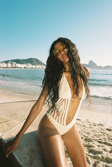 cream Hand crochet one piece bathing suit
Halter-tie and cheeky cutouts
Tie-front center detail
Thong coverage