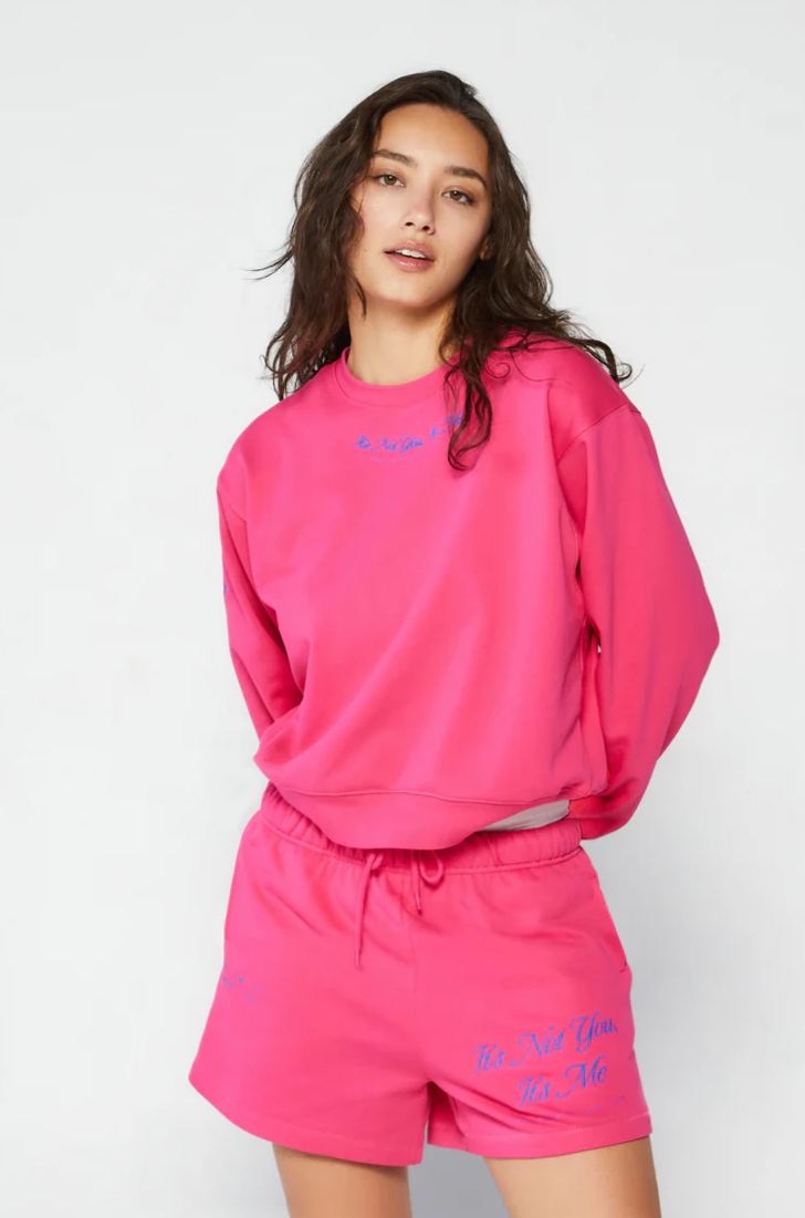 Graphic printed knit sweatshirt. Cropped fit. Unlined. Pink cropped oversized sweater. Airport outfit. Loungewear. Relaxing outfit.